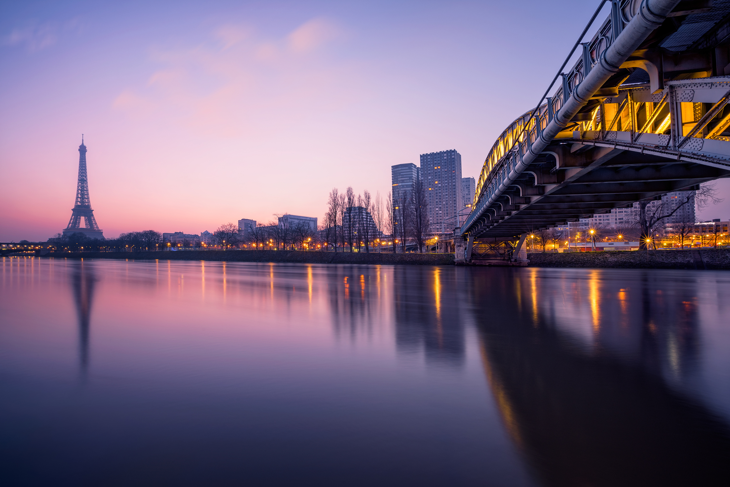 Cityscape of Paris with the Eiffel tower during the Blue hour before sunrise. The Rouelle bridge is on the right.